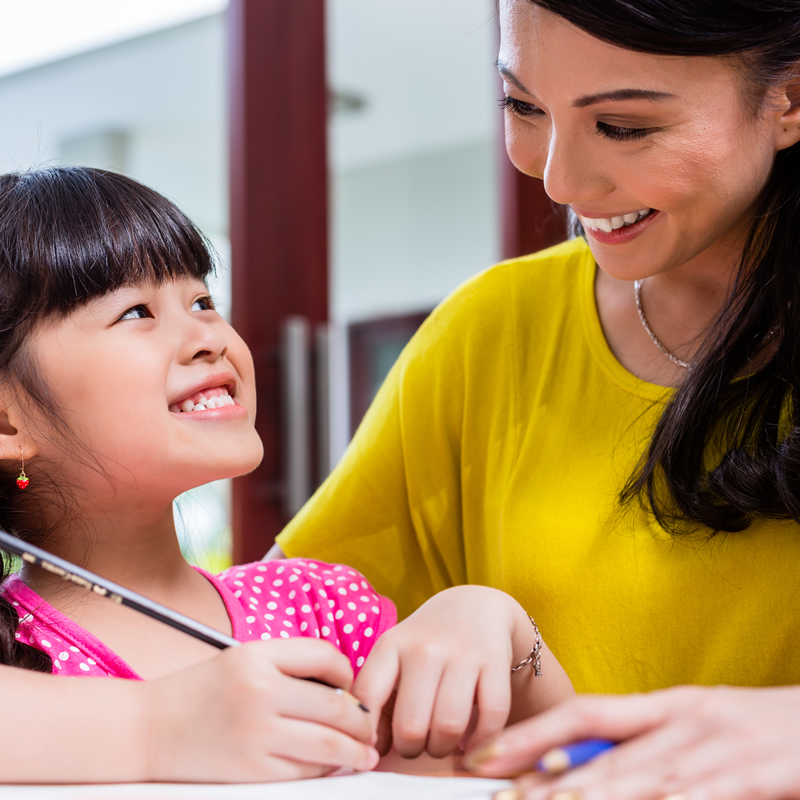 A parent encouraging their child with their homework